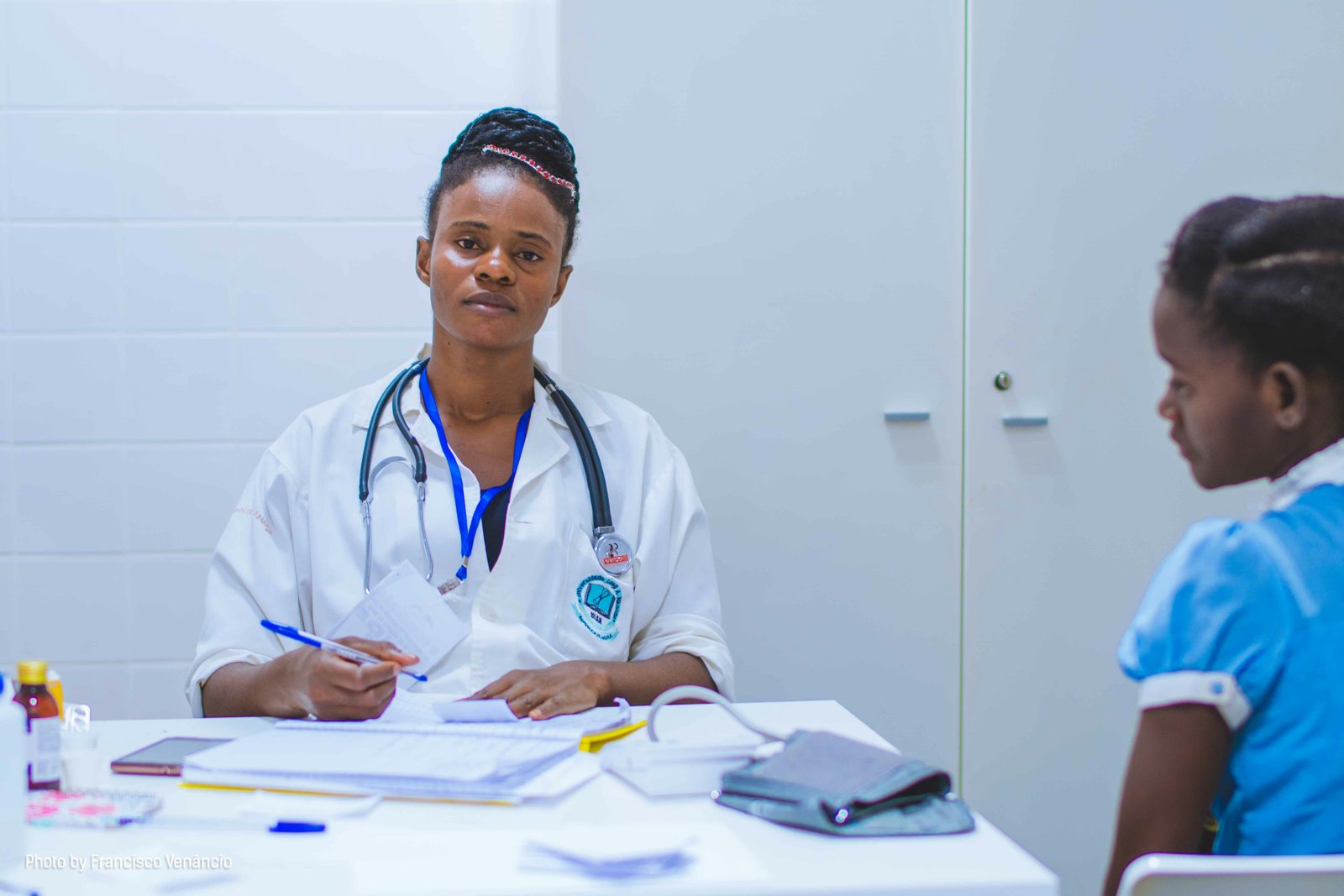 A doctor consulting with a young patient in a clinic.