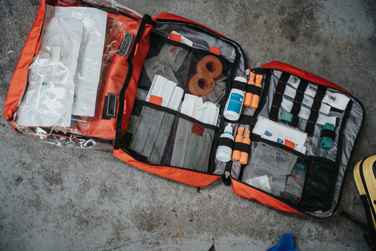 An open first aid kit showing organized medical supplies.