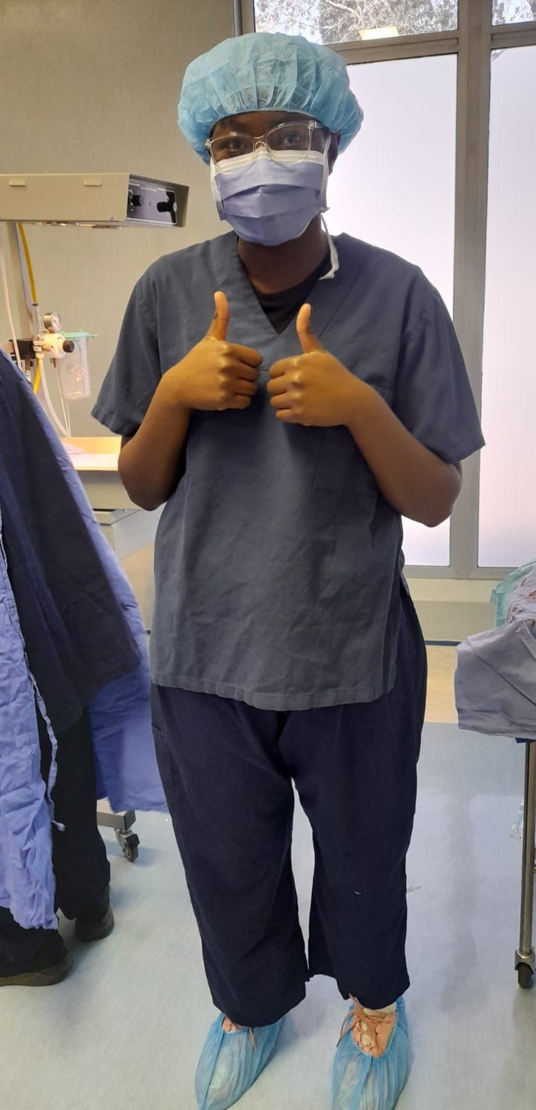 Celeste in scrubs during a clinical shadowing experience.