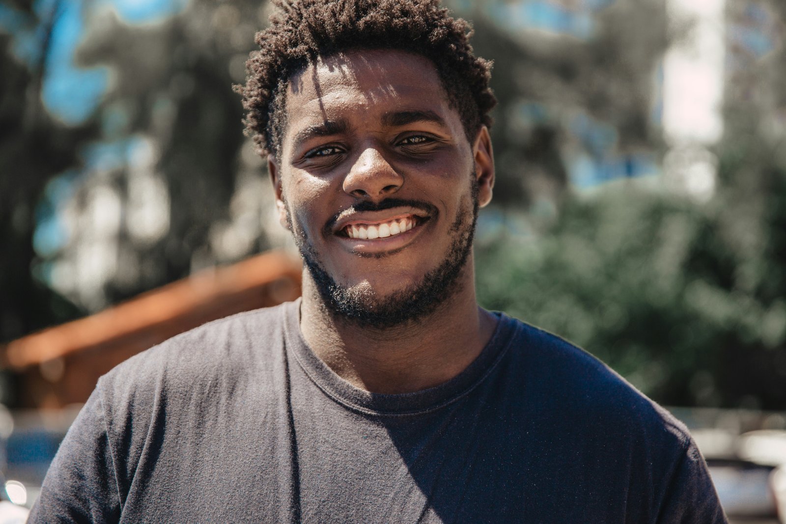 A smiling young man outdoors.