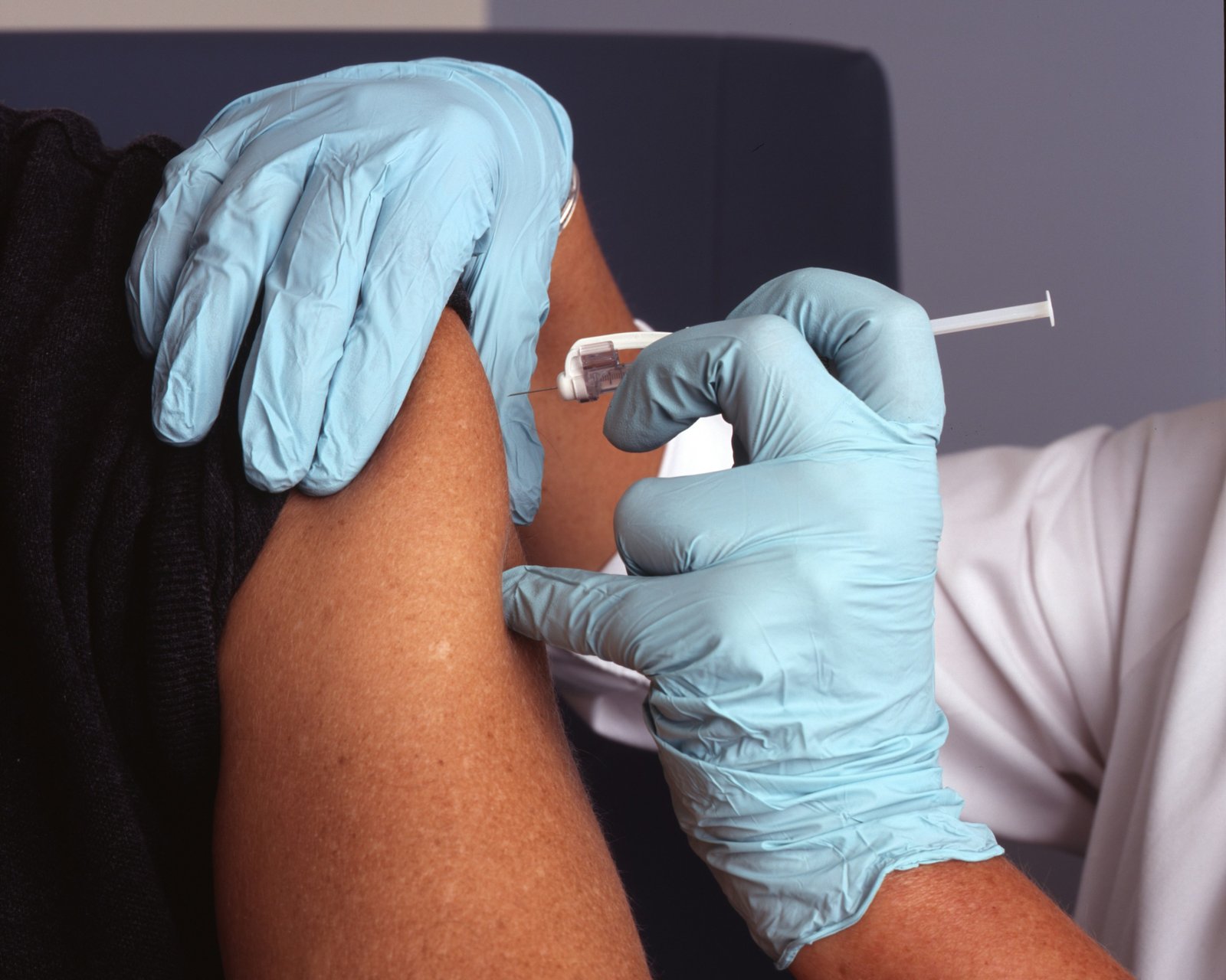 Close-up of a vaccine being administered into a patient's arm.