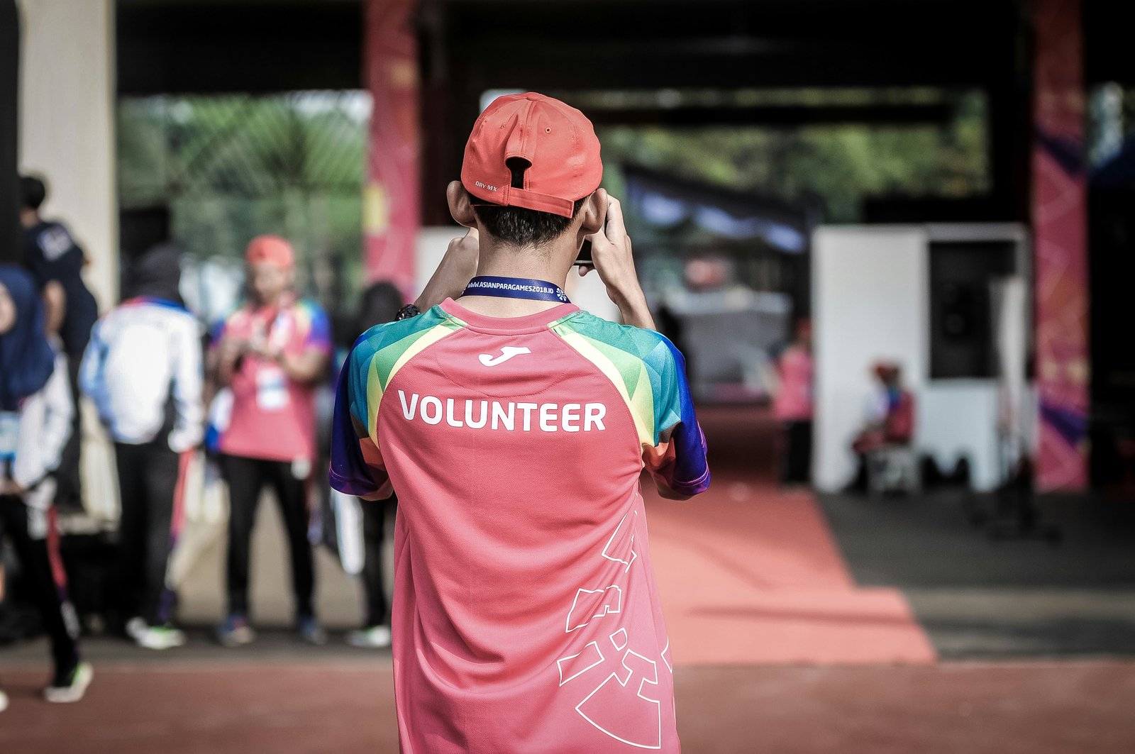 A volunteer wearing a jersey printed with the word 'Volunteer,' seen from behind.